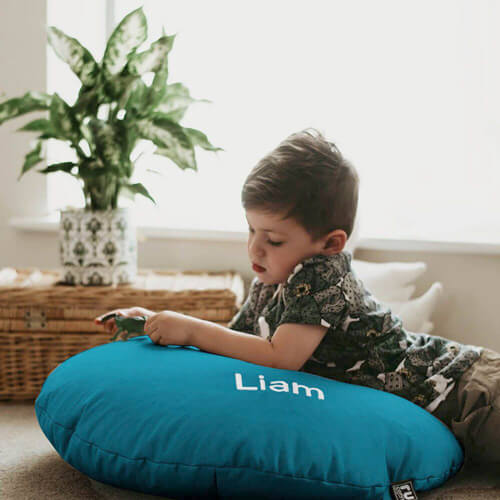 Little boy on personlaised smarty floor cushion